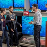 Salesperson assisting customers in TV Department