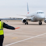 XNA Customer Service Agent marshaled in an aircraft.