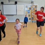 Coaches and child dancing 